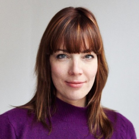 Anna Lena Schiller with long brown hair and violet pullover smiling lightly into the camera