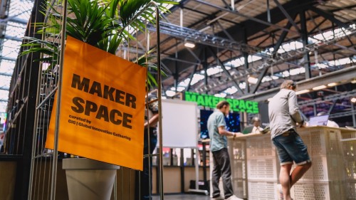 Ein Schild für den Maker Space auf der re:publica. Im Hintergrund sind Menschen zu erkennen.