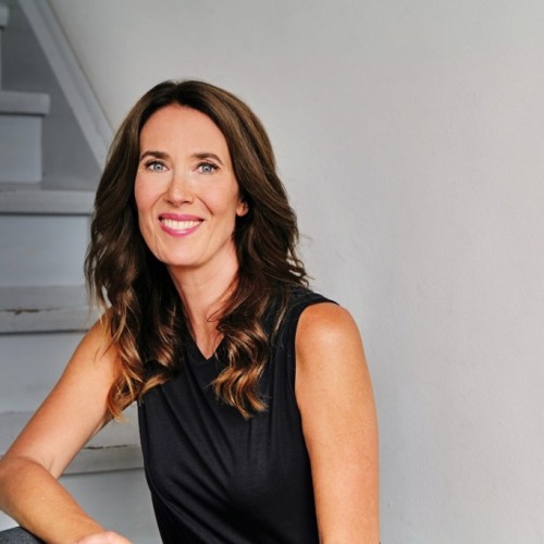 Anna Sophie Herken sits on the stairs and smiles at the camera