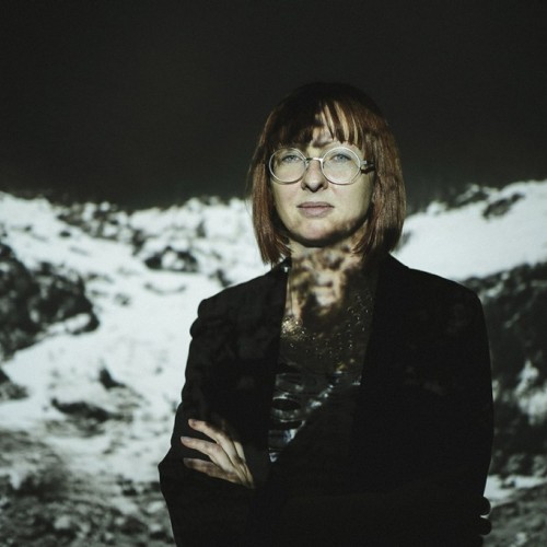 Portrait of Theresa Schubert with video projection behind