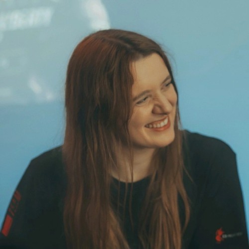 A picture of Carolin, long-hair brunette, smiling.