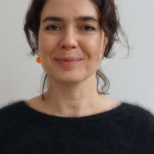 Headshot of a woman with dark hair and a black sweater