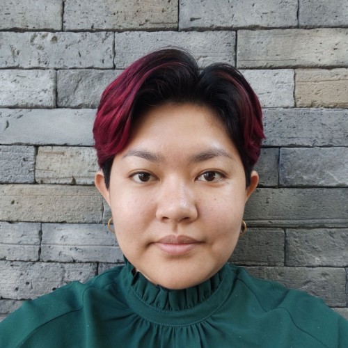 Picture of Aye Min Thant standing in front a brick wall