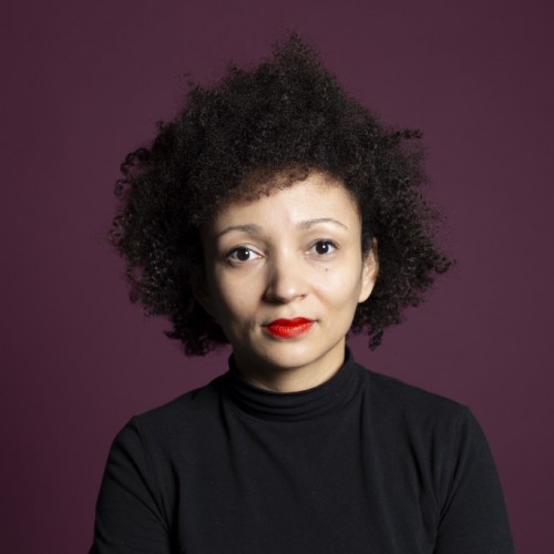 Junge Frau mit Afro und lila Hintergrund
