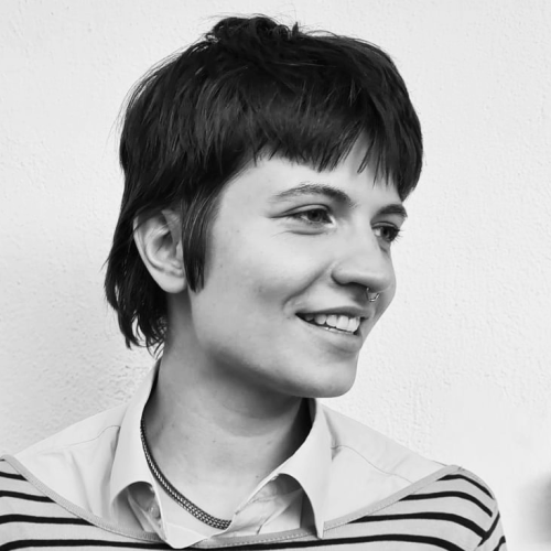 portrait in black and white, in front of empty white wall