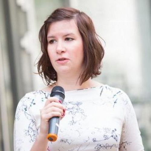 Regina Sipos speaks at a conference.